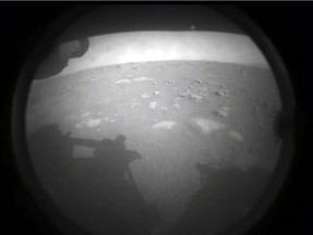 This NASA photo shows members of NASAs Perseverance rover as it landed on the surface of Mars on February 18, 2021. - NASA said February 18, 2021 that the Perseverance rover has touched down on the surface of Mars after successfully overcoming a risky landing phase known as the "seven minutes of terror." "Touchdown confirmed," said operations lead Swati Mohan at around 3:55 pm Eastern Time (2055 GMT) as mission control at NASA's Jet Propulsion Laboratory headquarters erupted in cheers. The autonomously-guided procedure was completed more than 11 minutes earlier, which is how long it takes for radio signals to return to Earth.