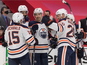 Edmonton Oilers players celebrate a goal scored by defenseman Evan Bouchard (75) in the first period against the Ottawa Senators at the Canadian Tire Centre on Feb. 9, 2021.