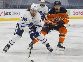 The Edmonton Oilers' Patrick Russell (52) chases the Toronto Maple Leafs' William Nylander (88) during second period NHL action at Rogers Place, in Edmonton Saturday Feb. 27, 2021.
