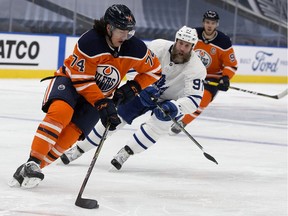 The Edmonton Oilers' Ethan Bear (74) battles the Toronto Maple Leafs' Joe Thornton (97) during second period NHL action at Rogers Place, in Edmonton Saturday Feb. 27, 2021.