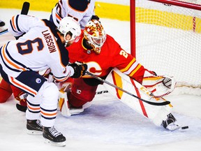 Adam Larsson (6) of the Edmonton Oilers scores against goaltender Jacob Markstrom (25) of the Calgary Flames at Scotiabank Saddledome on March 15, 2021, in Calgary.