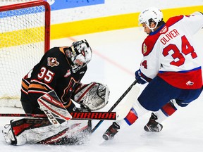 Brayden Peters (35) of the Calgary Hitmen stops a shot from Kaid Oliver (34) of the Edmonton Oil Kings at Seven Chiefs Sportsplex on March 27, 2021, in Calgary.