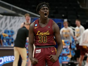Aher Uguak (30) of the Loyola University Chicago Ramblers reacts after drawing a foul against the University of Illinois Fighting Illini in the second round of the 2021 NCAA tournament at Bankers Life Fieldhouse on March 21, 2021, in Indianapolis, Indiana.