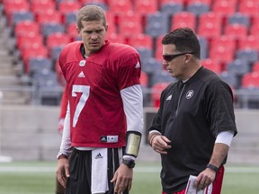 Ottawa Redblacks quarterback Trevor Harris, left, talks with offensive co-ordinator Jaime Elizondo during practice at TD Place Stadium in this file photo taken August 7, 2018.