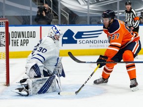 Edmonton Oilers Connor McDavid (97) is stopped by Toronto Maple Leafs goaltender Michael Hutchinson during third period NHL action at Rogers Place in Edmonton, on Monday, March 1, 2021.