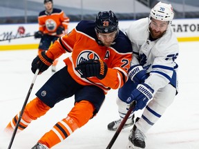 Edmonton Oilers centre Leon Draisaitl (29) battles Toronto Maple Leafs forward TJ Brodie (78) during third period NHL action at Rogers Place in Edmonton, on Wednesday, March 3, 2021.