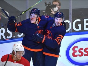 Edmonton Oilers Jesse Puljujarvi (13) celebrates his goal with Leon Draisaitl (29) against the Calgary Flames during NHL action at Rogers Place in Edmonton, March 6, 2021.