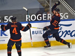 Edmonton Oilers Connor McDavid (97) celebrates what turns out to be the winning goal with Kris Russell (4) defeating the Calgary Flames 3-2 during NHL action at Rogers Place in Edmonton, March 7, 2021.