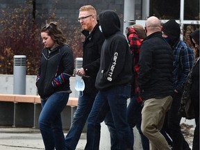 Pastor James Coates, carrying a mask in his hands, walks out of the Remand Centre with a group of supporters after being released from the facility late Monday afternoon in Edmonton, March 22, 2021. Ed Kaiser/Postmedia