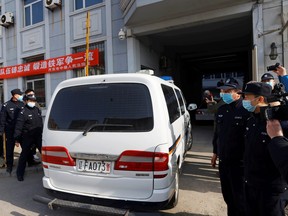 A police vehicle believed to be carrying Michael Spavor arrives at Intermediate People's Court, where Spavor was to stand trial, in Dandong, Liaoning province, China March 19, 2021.
