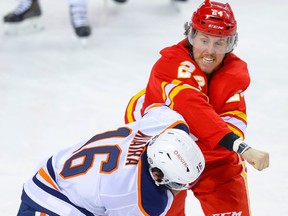 Edmonton Oilers forward Jujhar Khaira fights Brett Ritchie of the Calgary Flames in Calgary on Monday, March 15, 2021.