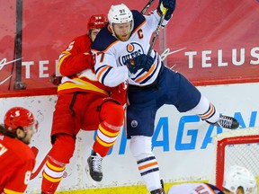 Calgary Flames' Noah Hanifin collides with Connor McDavid of the Edmonton Oilers in Calgary on March 15, 2021.