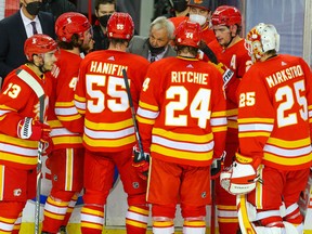 Calgary Flames head coach Darryl Sutter gives instructions to his team during a timeout against the Edmonton Oilers in Calgary on Monday, March 15, 2021.