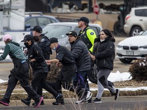 Shoppers are evacuated from a King Soopers grocery store after a gunman opened fire in Boulder, Colo., Monday, March 22, 2021.