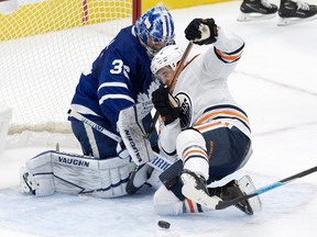 Edmonton Oilers right winger Josh Archibald (15) runs into Toronto Maple Leafs goaltender Jack Campbell (36) while chasing the puck in Toronto on March 27, 2021.