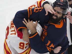 Edmonton Oilers' Jujhar Khaira (16) and Calgary Flames' Sam Bennett (93) fight on Feb. 20, 2021, in Edmonton.