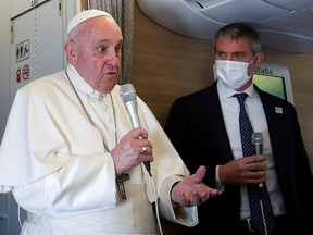 Pope Francis gives a news conference aboard the papal plane on his flight back after visiting Iraq, March 8, 2021.