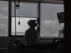 A medical staff tends to a patient at the intensive care unit for patients patients infected with Covid-19 at the Trinidad Teaching Medical Center, in Caracas, on March 19, 2021.