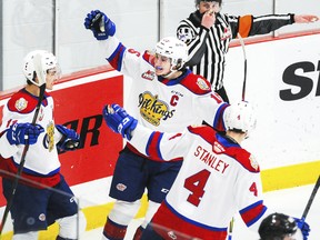 Edmonton Oil Kings captain Scott Atkinson celebrates a goal with Dylan Guenther (11) and Ross Stanley 
(4) against the Calgary Hitmen at Seven Chiefs Sportsplex on March 27, 2021, in Calgary.