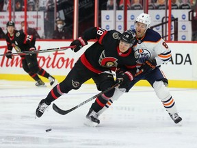 Tim Stützle #18 of the Ottawa Senators battles for the puck against Kyle Turris #8 of the Edmonton Oilers in the second period at Canadian Tire Centre on April 7, 2021 in Ottawa.