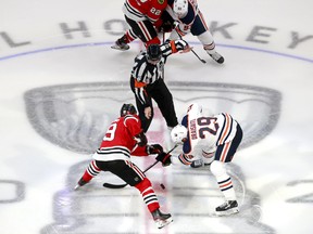 Jonathan Toews (19) of the Chicago Blackhawks and Leon Draisaitl (29) of the Edmonton Oilers face off in Game 4 of the Western Conference qualification round prior to the 2020 NHL Stanley Cup Playoffs at Rogers Place on August 07, 2020, in Edmonton.