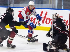Edmonton Oil Kings’ Dylan Guenther (11) shoots on Red Deer Rebels’ goaltender Ethan Anders  during the first period of a WHL game at the Downtown Community Arena at Rogers Place in Edmonton, on Sunday, March 21, 2021.