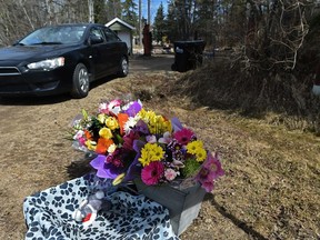 A flower memorial outside the Paterson-Gartner home in Strathcona County, where tax lawyer Greg Gartner killed wife Lois Paterson-Gartner and their 13-year-old daughter Sarah on May 4, 2020. Gartner then took his own life. In March, Gartner's estate filed a lawsuit against Gartner's former colleagues saying they are withholding money. The defendants deny any wrongdoing.