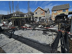 An early morning fire destroyed a detached garage and heavily damaged another as eight fire crews battled the blaze along Stanton Drive near 60 Street, Friday, April 9, 2021.