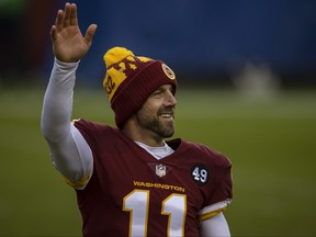 Alex Smith of the Washington Football Team waves after the game against the Dallas Cowboys at FedExField on Oct. 25, 2020 in Landover, Md.