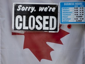 A "closed" sign hangs in a store window in Ottawa, Thursday April 16, 2020.