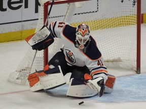 Edmonton Oilers goalie Mike Smith (41) makes a save against the Ottawa Senators at the Canadian Tire Centre on Thursday, April 8, 2021.