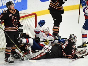 The Edmonton Oil Kings and Calgary Hitmen have a pileup in the crease during  game at Seven Chiefs Sportsplex in Calgary on March 27, 2021.