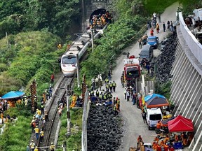 This photo shows rescue workers at the site where a train derailed inside a tunnel in the mountains of Hualien, eastern Taiwan on April 2, 2021.