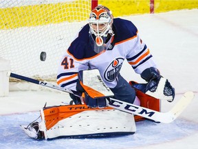 Edmonton Oilers goaltender Mike Smith makes a save against the Calgary Flames during the first period at Scotiabank Saddledome.