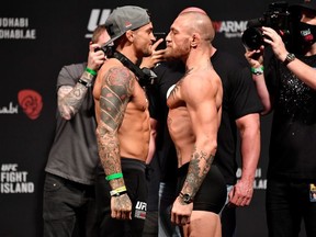 Dustin Poirier and Conor McGregor of Ireland face off during the UFC 257 weigh-in at Etihad Arena on UFC Fight Island on January 22, 2021 in Abu Dhabi, United Arab Emirates.