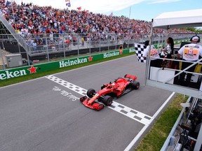 Formula One F1 - Canadian Grand Prix - Circuit Gilles Villeneuve, Montreal, Canada - June 10, 2018 Ferrari's Sebastian Vettel passes the chequered flag to win the race.