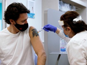 Canada's Prime Minister Justin Trudeau is inoculated with AstraZeneca's vaccine against coronavirus disease (COVID-19) at a pharmacy in Ottawa, Ontario, Canada, on Friday, April 23, 2021.