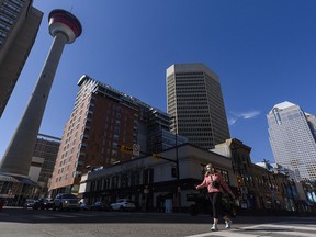 A masked pedestrian crosses the Centre Street in downtown Calgary on Friday, April 16, 2021.
