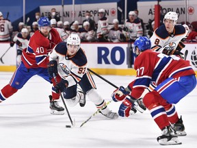 Ryan Nugent-Hopkins (93) of the Edmonton Oilers skates the puck past Joel Armia (40) of the Montreal Canadiens at Bell Centre on Wednesday, May 12, 2021, in Montreal, Canada.