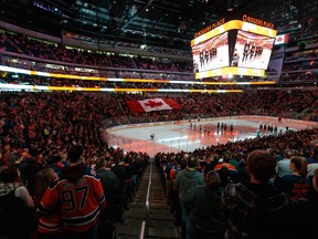 Hockey fans sing O Canada before the Edmonton Oilers play the Minnesota Wild at Rogers Place in Edmonton on Feb. 21, 2020.