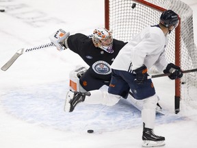 The Edmonton Oilers' Dominik Kahun (21) gets a shot past goalie Alex Stalock (32) during a team practice at Rogers Place, in Edmonton Friday May 14, 2021.