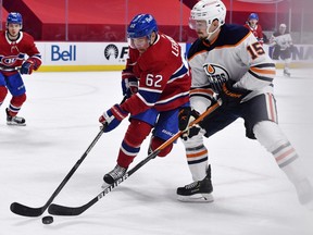 Montreal Canadiens forward Artturi Lehkonen (62) and Edmonton Oilers forward Josh Archibald (15) battle for the puck during the first period at the Bell Centre.