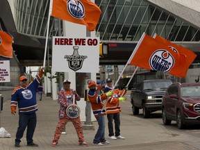 Oilers fans wave at traffic in front of Rogers Place as the Oilers get ready to play the Winnipeg Jets in the first game of the opening series of the NHL North Division playoffs on Wednesday, May 19, 2021.