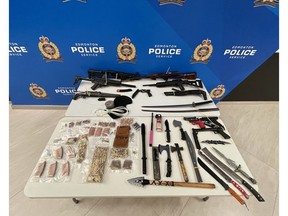 Items seized during the execution of a search warrant on May 21, 2021, in Edmonton's northwest are displayed in a photo supplied by the Edmonton Police Service.