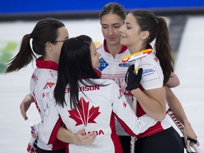 Team Canada skip Kerri Einarson (back) celebrates with teammates (L-R) Val Sweeting, Briane Meilleur, and Shannon Birchard after Canada defeated Italy 10-4 at the world women’s championship in Calgary.