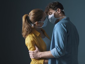 Young loving couple wearing face masks