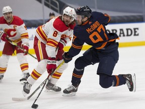 Edmonton Oilers Connor McDavid (97) scores on the Calgary Flames as he gets the puck past Christopher Tanev (8) during first period NHL action on Saturday, May 1, 2021 in Edmonton.