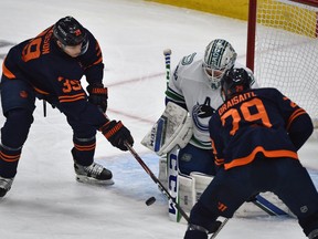 Edmonton Oilers Alex Chiasson (39) and Leon Draisaitl (29) neither could get the puck past Vancouver Canucks goalie Thatcher Demko (35) during NHL action at Rogers Place in Edmonton, May 6, 2021.