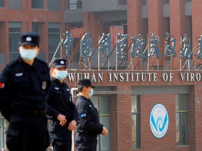 Security guards keep watch outside the Wuhan Institute of Virology during the visit by the World Health Organization (WHO) team in Wuhan, China February 3, 2021.