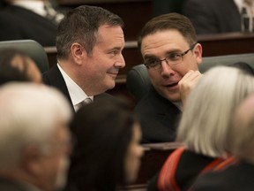 Premier Jason Kenney and government house leader Jason Nixon in the legislature in 2019.